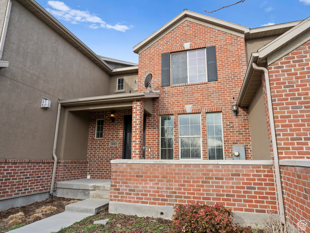 Exterior space featuring brick siding