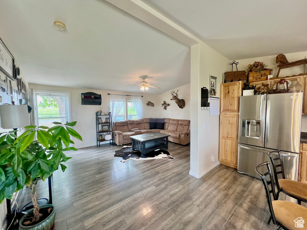Living room featuring a wealth of natural light, ceiling fan, and wood finished floors