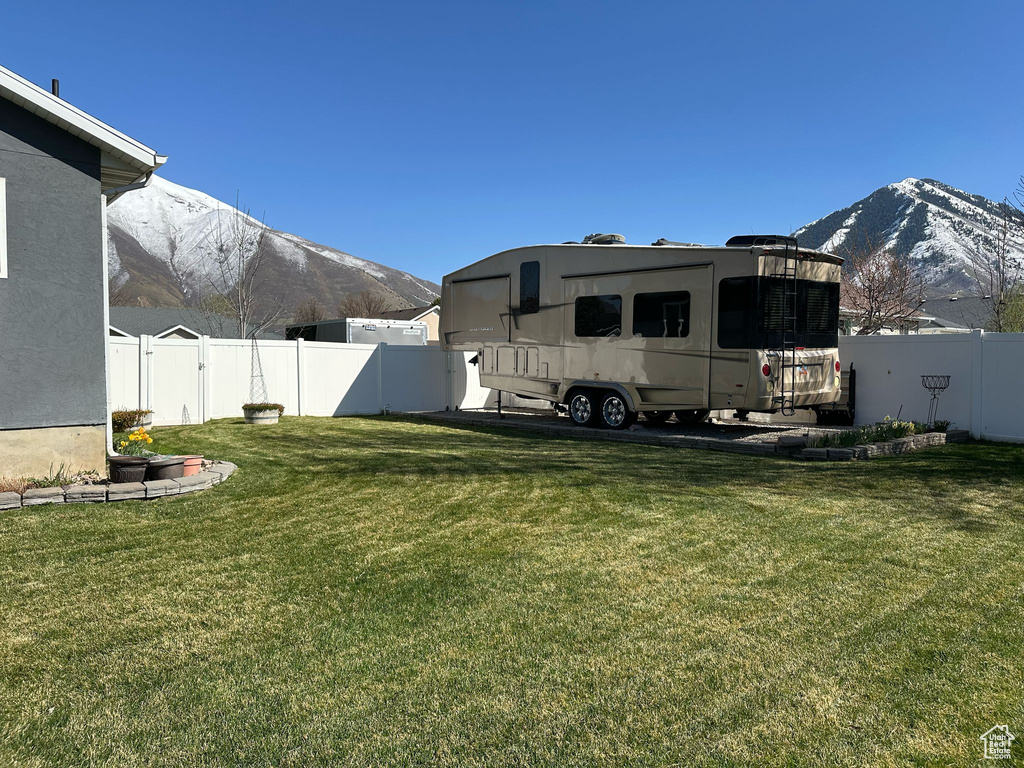 View of yard with a fenced backyard and a mountain view