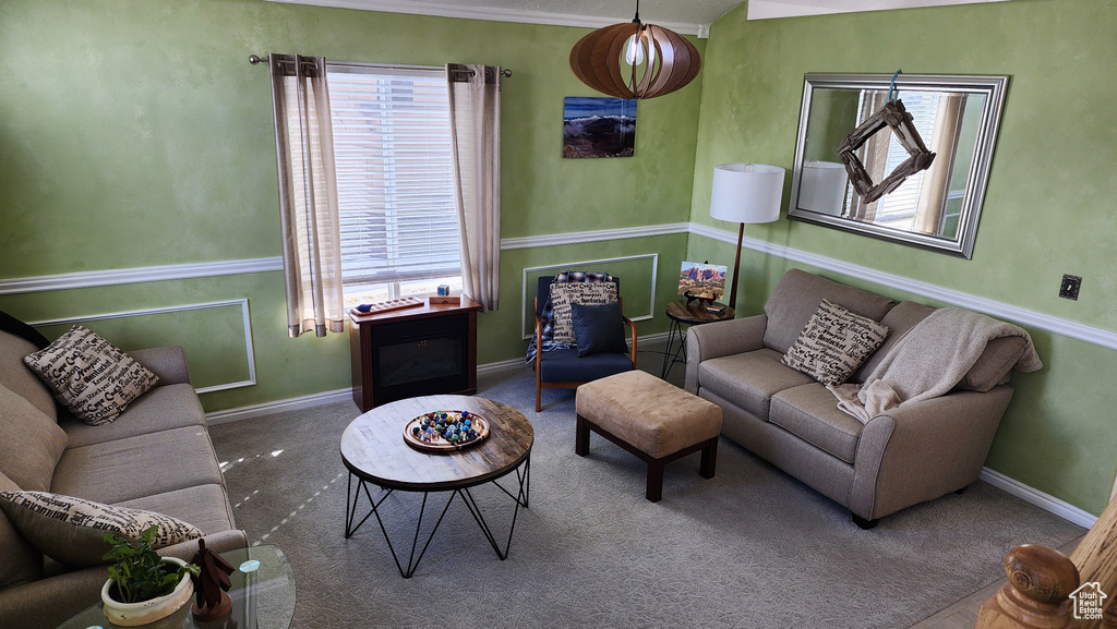 Carpeted living area featuring baseboards