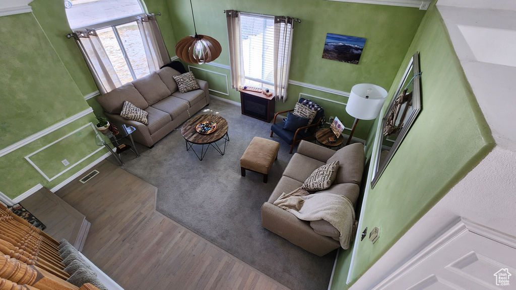 Living area with wood finished floors and visible vents