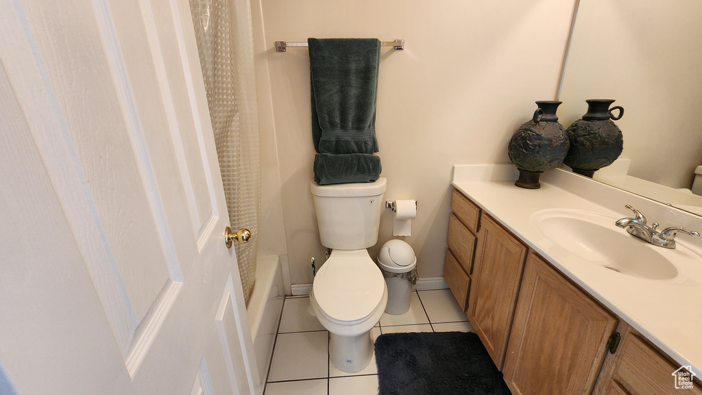 Bathroom featuring tile patterned floors, toilet, and vanity