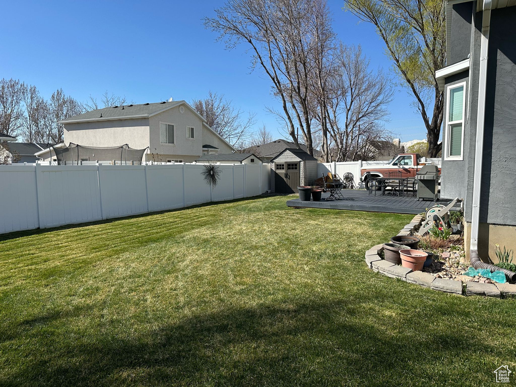 View of yard featuring a fenced backyard, an outbuilding, a patio, and a storage shed