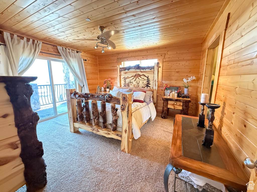 Carpeted bedroom with wood ceiling, access to outside, and wood walls