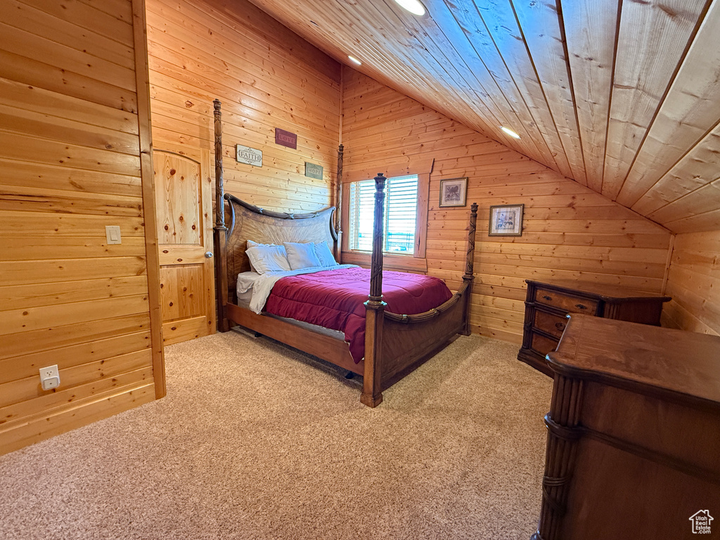 Bedroom with lofted ceiling, carpet flooring, wood walls, recessed lighting, and wood ceiling