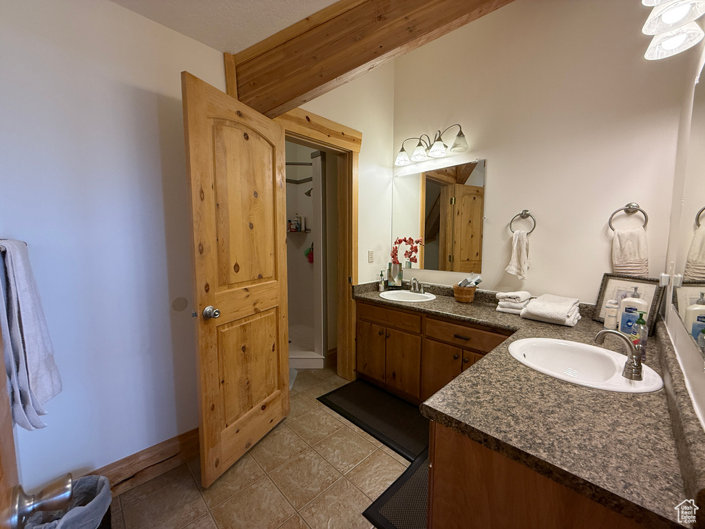 Bathroom with double vanity and a shower stall
