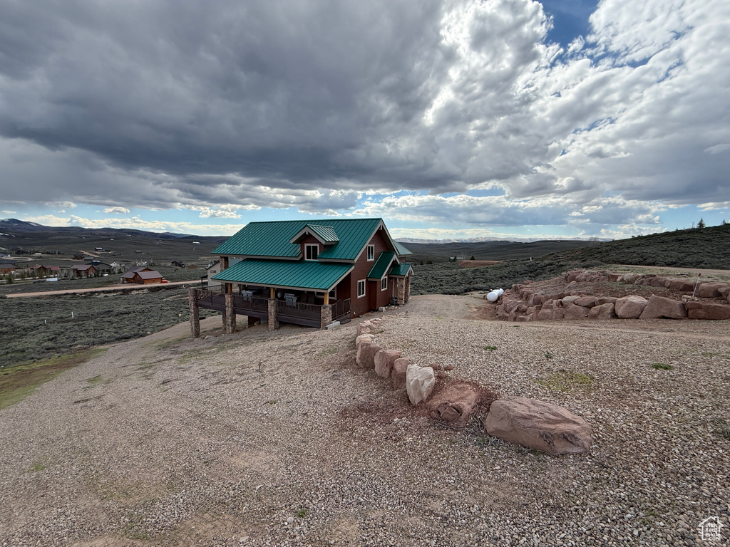 View of outdoor structure with a mountain view and gravel driveway