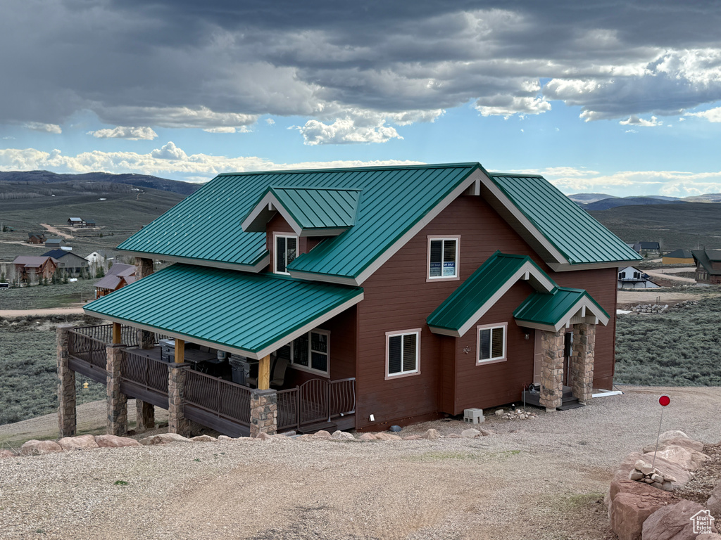 View of front facade with a standing seam roof, metal roof, and a mountain view