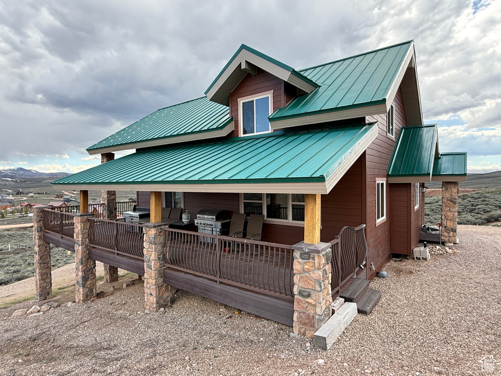 Back of house featuring metal roof and a standing seam roof