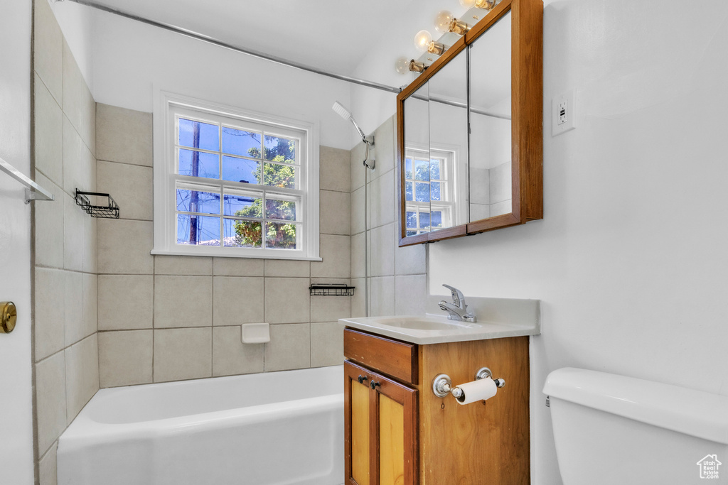 Full bath with toilet, vanity, and shower / tub combination