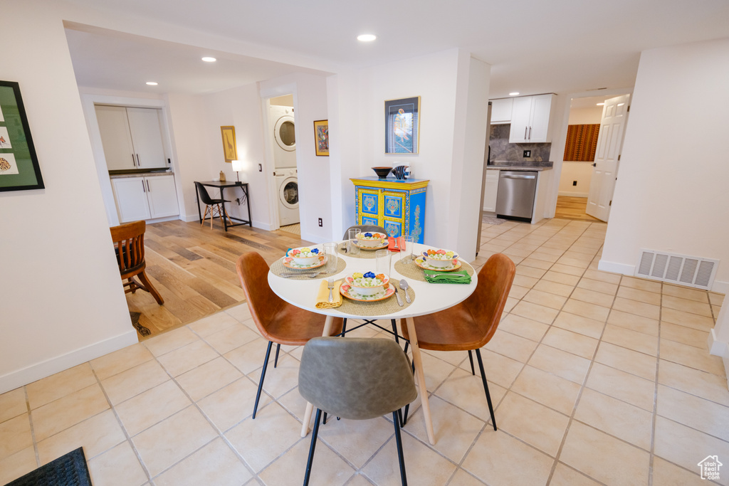 Dining room featuring visible vents, recessed lighting, stacked washer / dryer, light tile patterned floors, and baseboards