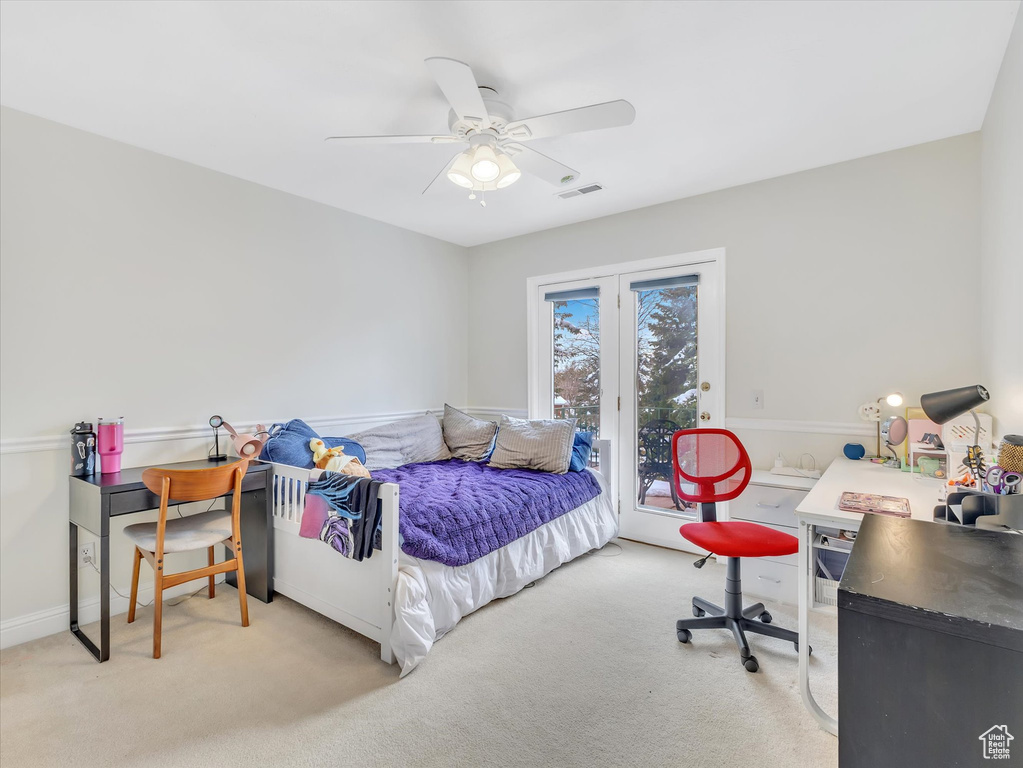 Carpeted bedroom with access to exterior, visible vents, and ceiling fan