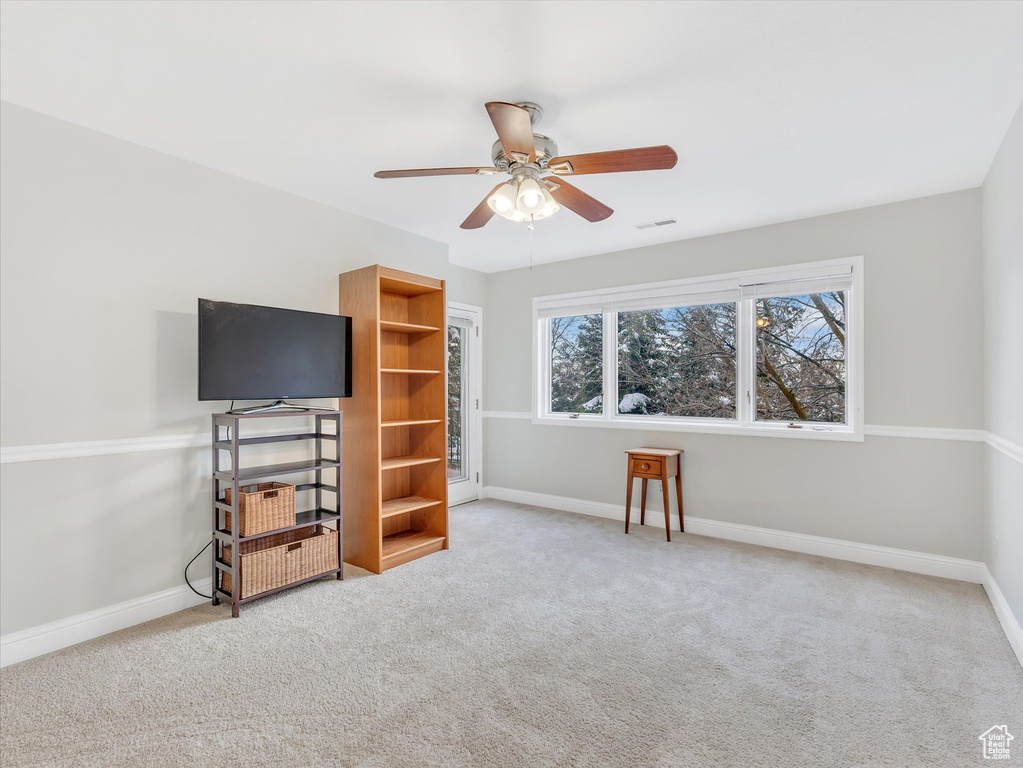 Interior space with visible vents, a ceiling fan, baseboards, and carpet floors