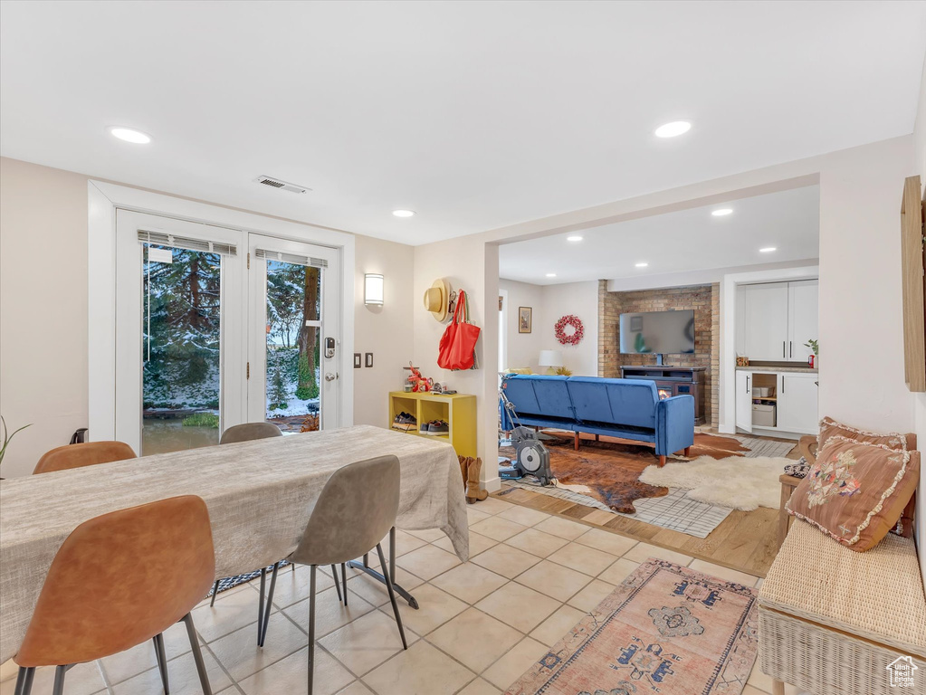 Dining area with light tile patterned flooring, recessed lighting, and visible vents