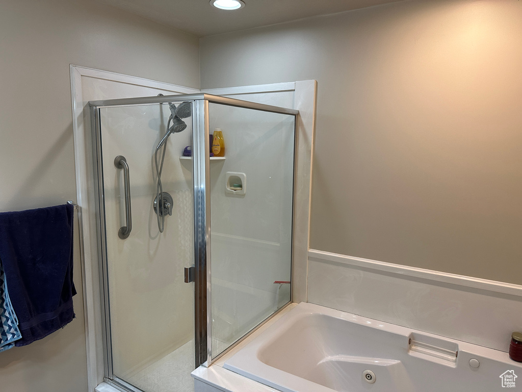 Full bath featuring a shower stall, a whirlpool tub, and recessed lighting