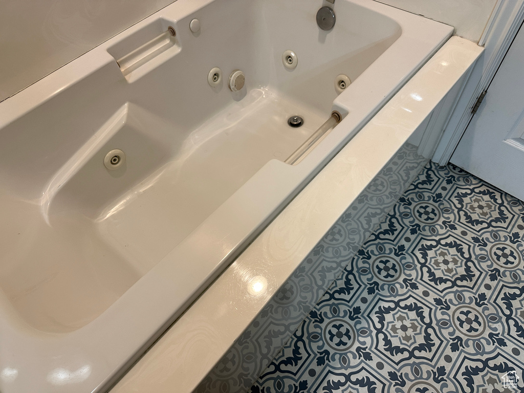 Bathroom with tile patterned floors and a whirlpool tub