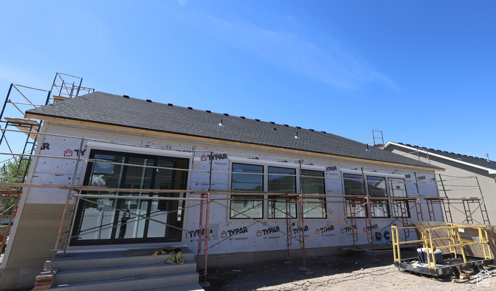 Back of house with roof with shingles