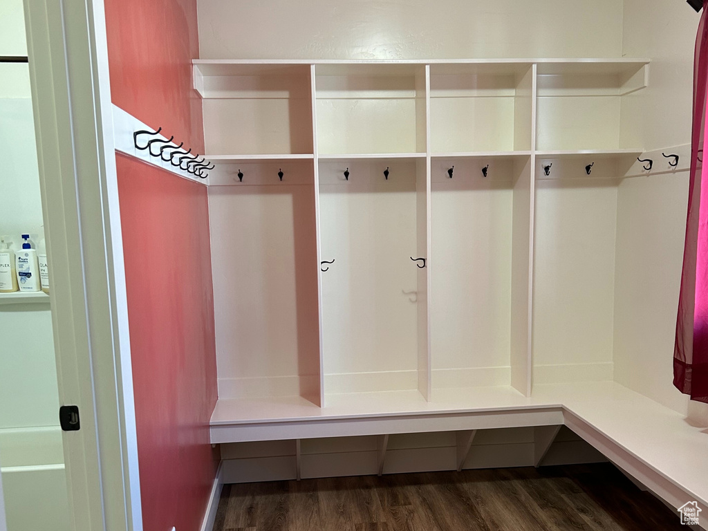 Mudroom with baseboards, a textured ceiling, and dark wood-style flooring