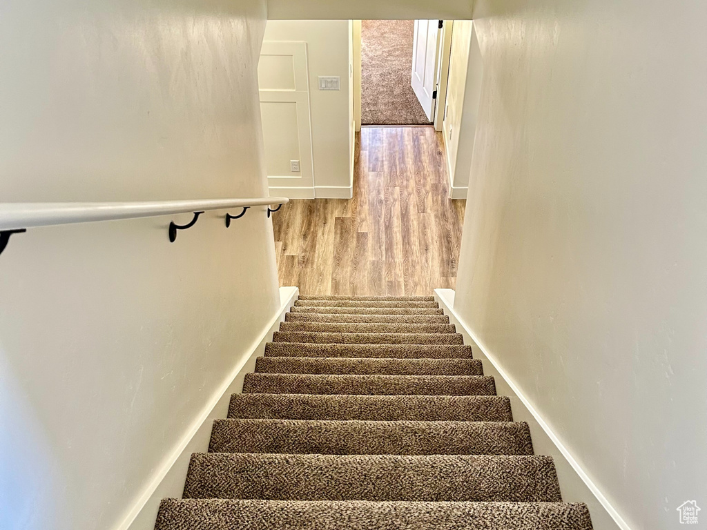 Stairs featuring baseboards and wood finished floors