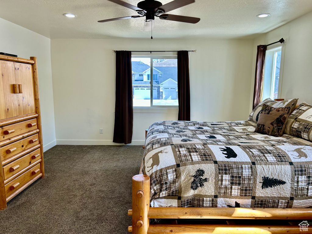 Bedroom with recessed lighting, carpet, baseboards, and a textured ceiling