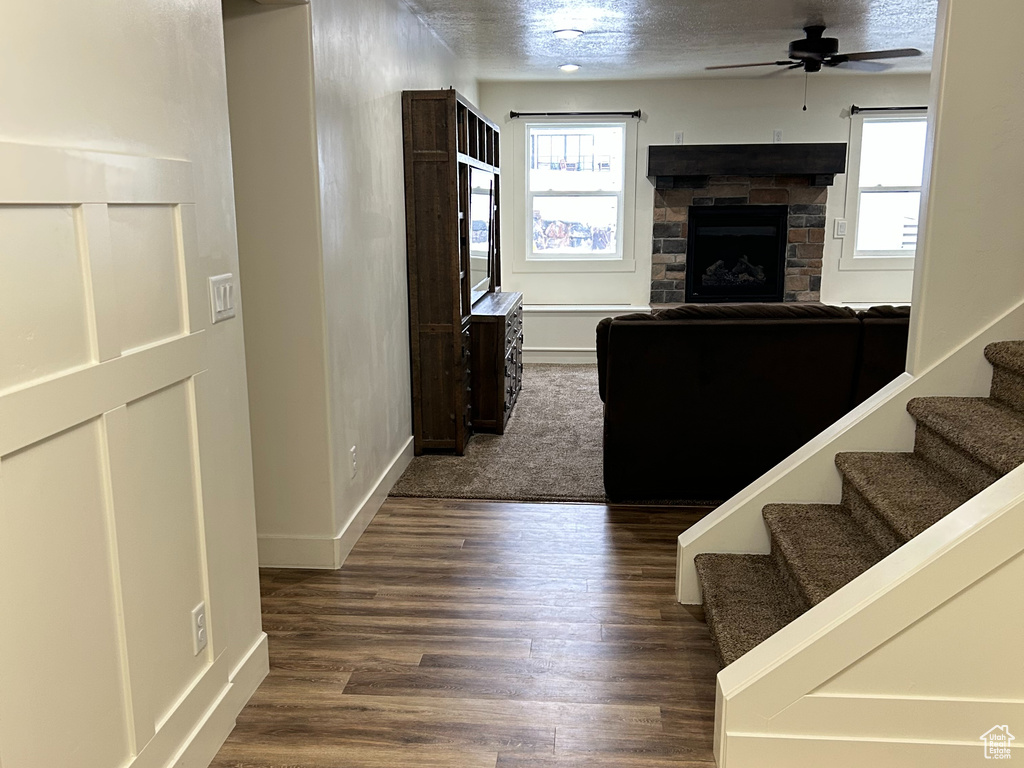 Interior space featuring plenty of natural light, a textured ceiling, a decorative wall, and wood finished floors
