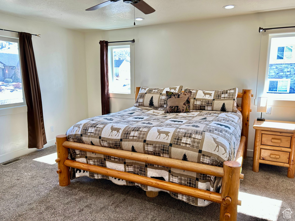Bedroom with carpet, baseboards, visible vents, recessed lighting, and a textured ceiling