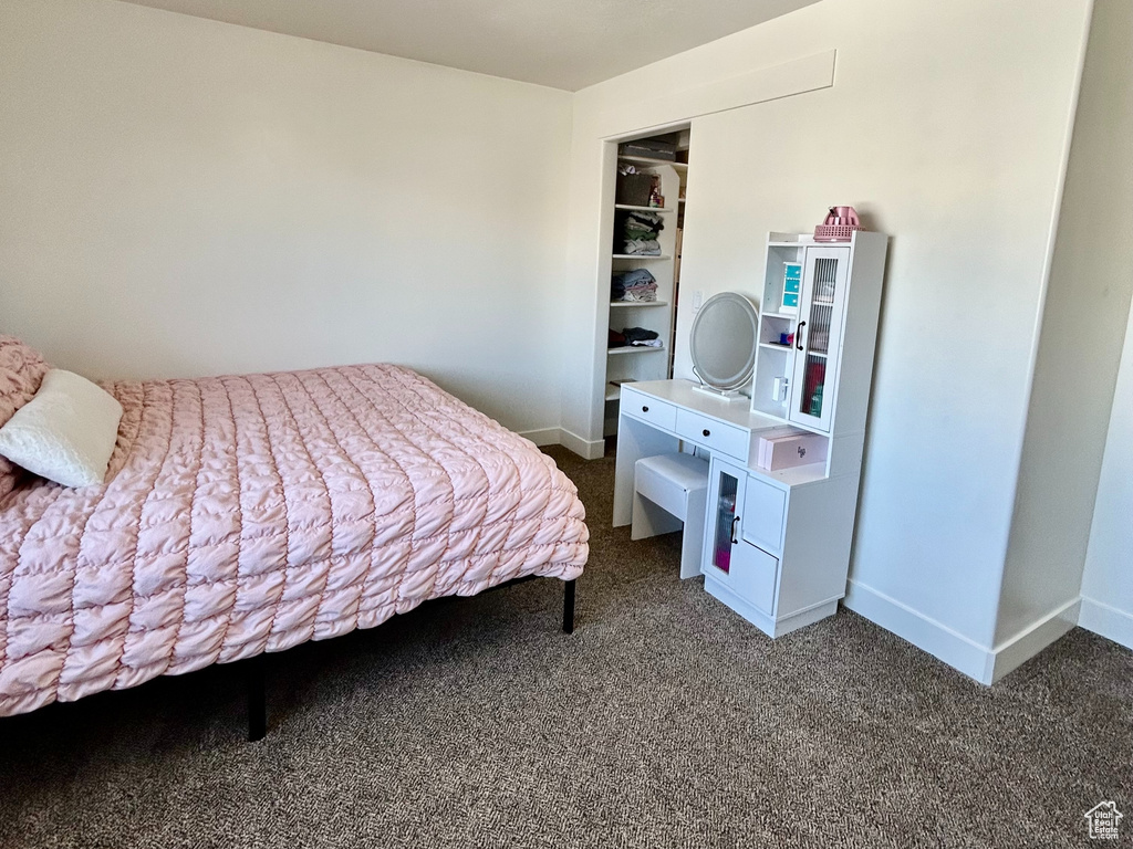Carpeted bedroom with baseboards and a textured ceiling