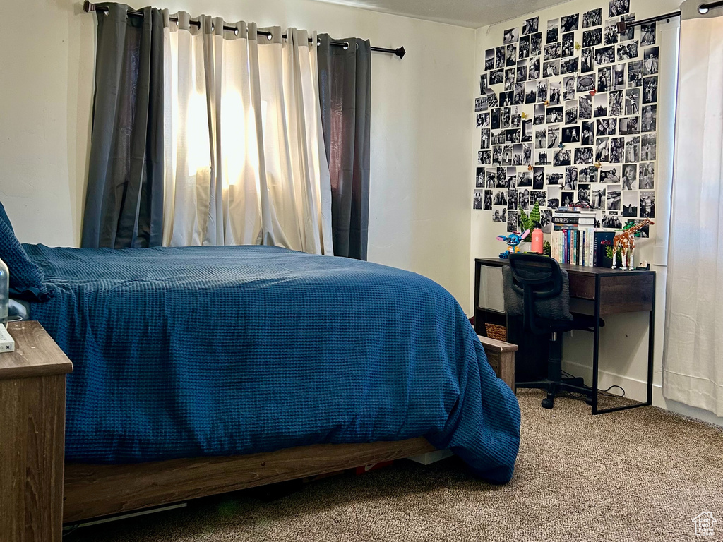 Carpeted bedroom featuring visible vents, a textured ceiling, and ceiling fan