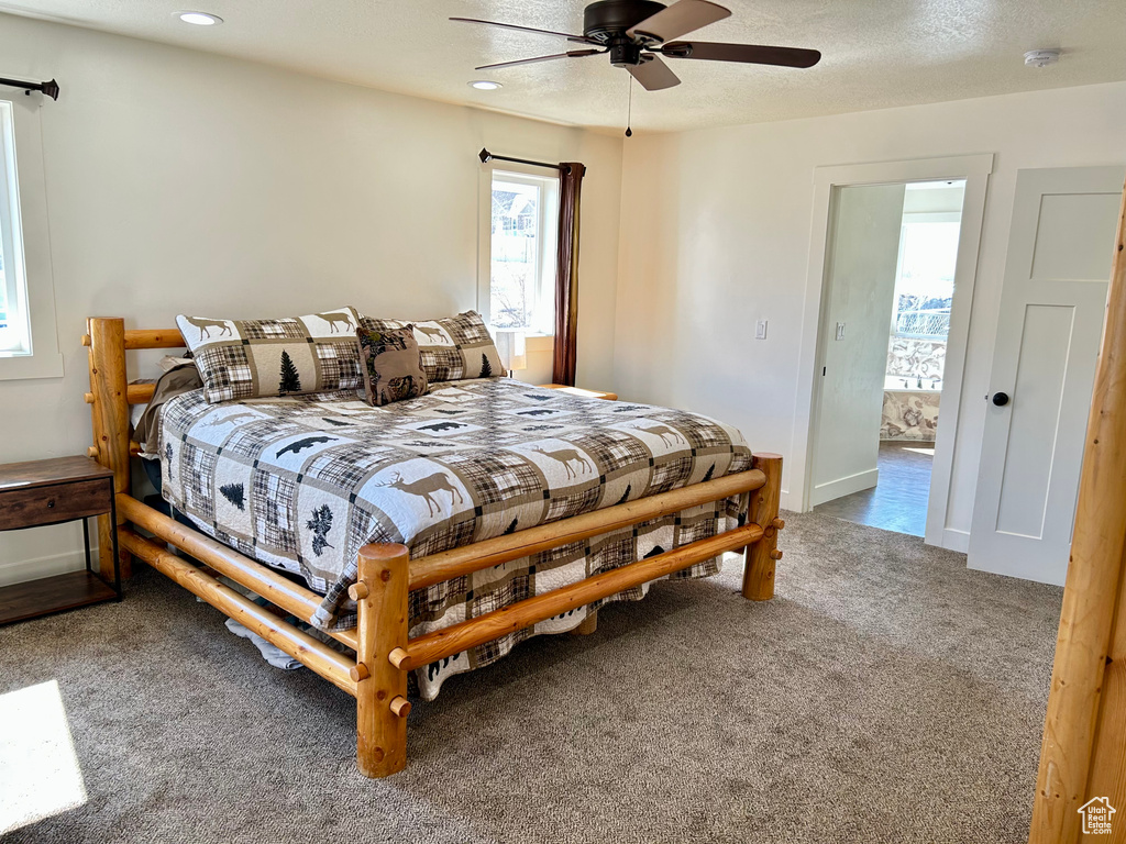 Bedroom featuring baseboards, carpet, recessed lighting, a textured ceiling, and a ceiling fan