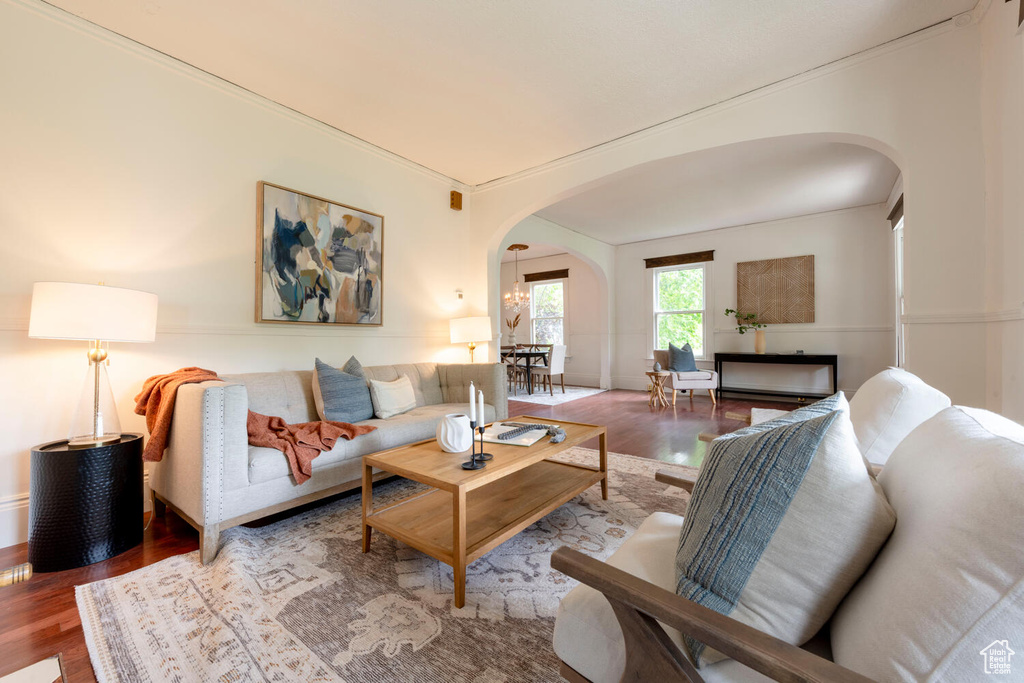 Living room featuring arched walkways and wood finished floors