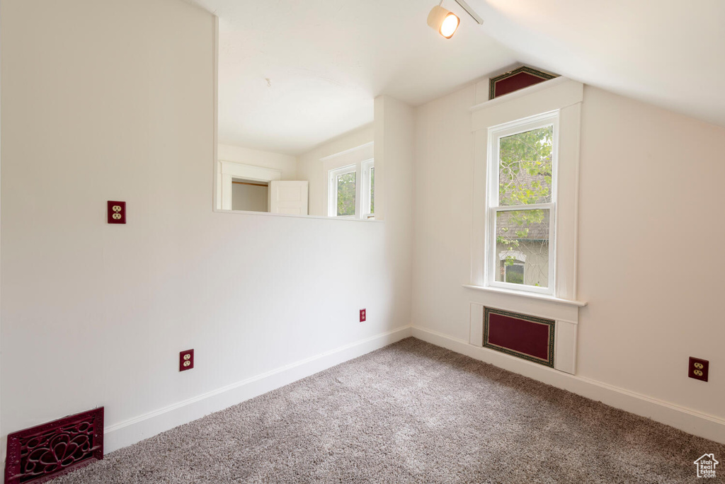 Bonus room featuring carpet flooring, baseboards, and lofted ceiling