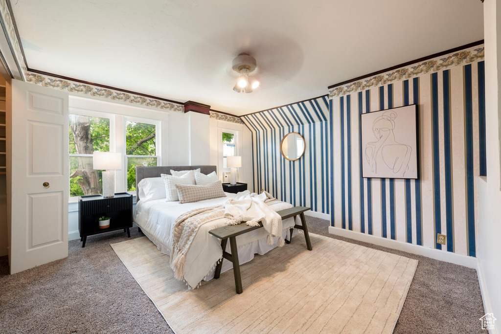 Carpeted bedroom with wallpapered walls