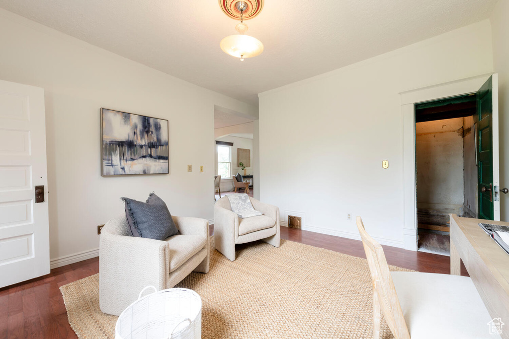 Living area with wood finished floors and baseboards
