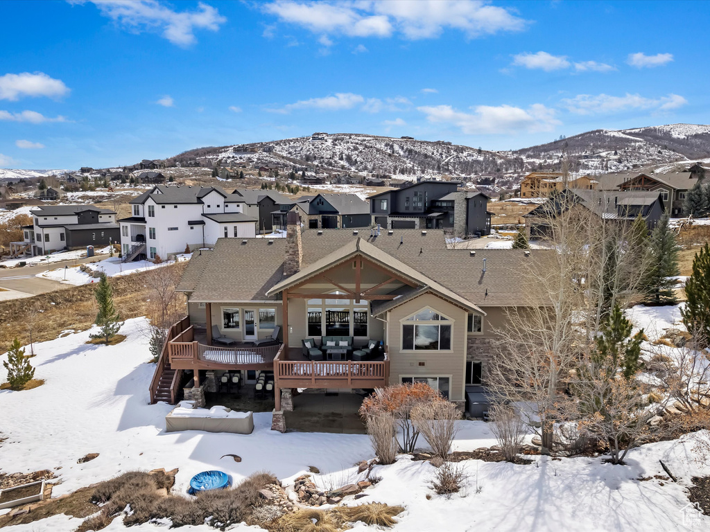 Snowy aerial view featuring a residential view and a mountain view