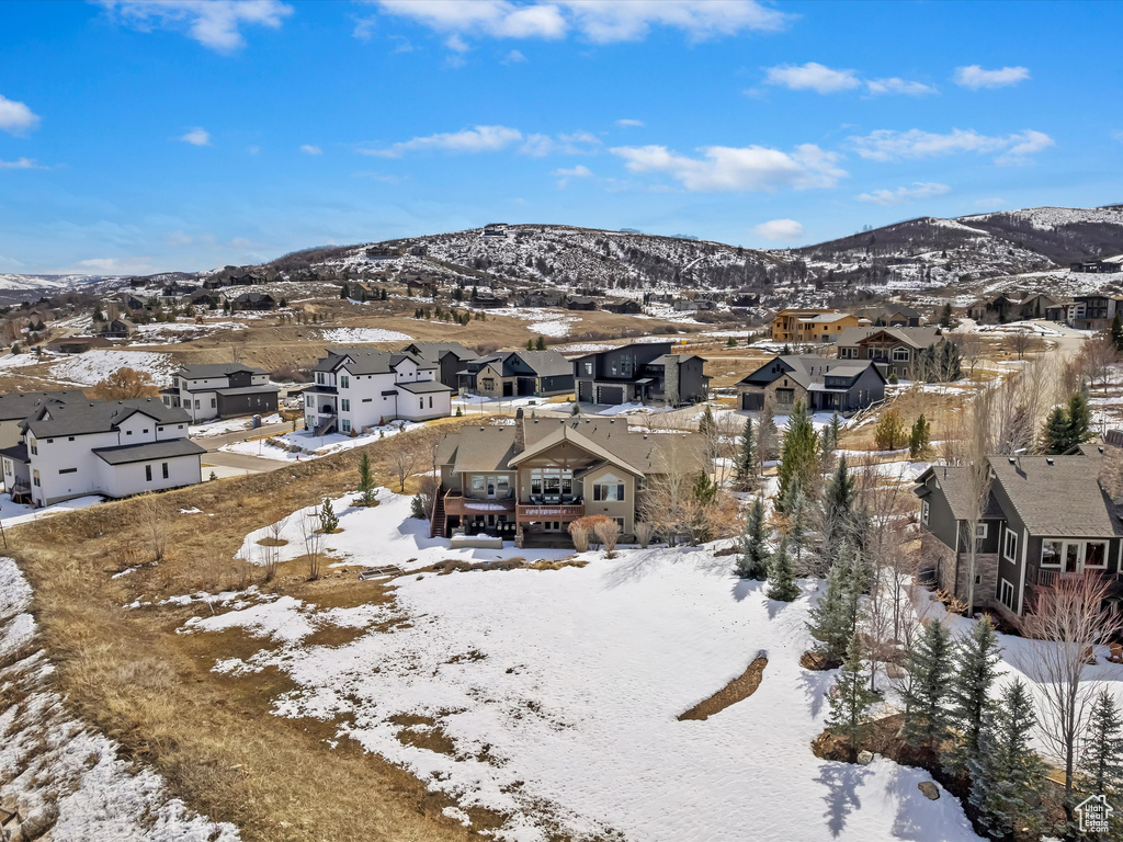 Snowy aerial view with a residential view and a mountain view