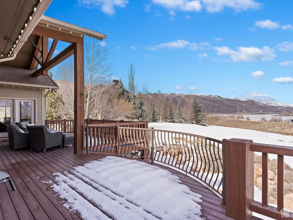 Snow covered deck with a mountain view