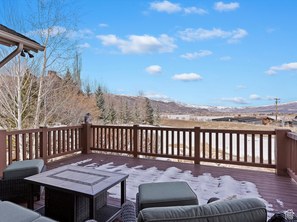 Deck with a mountain view and area for grilling
