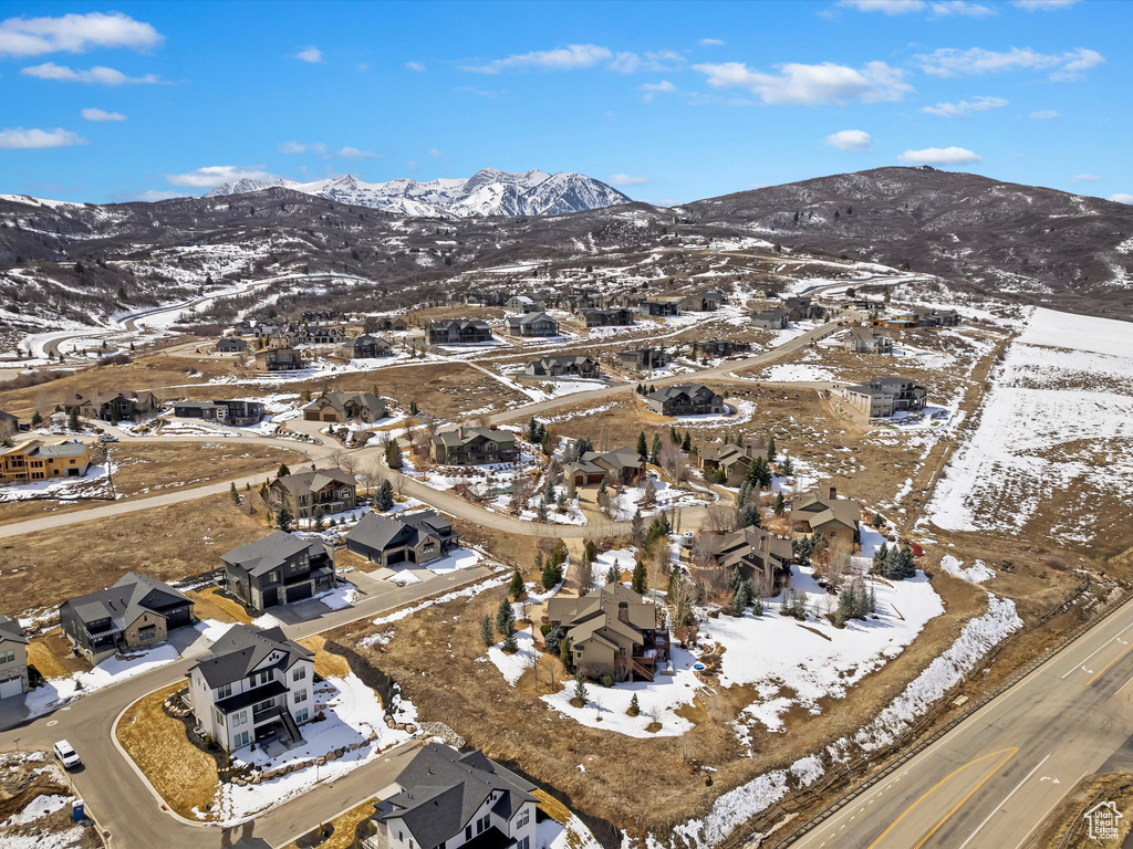 Snowy aerial view with a mountain view and a residential view