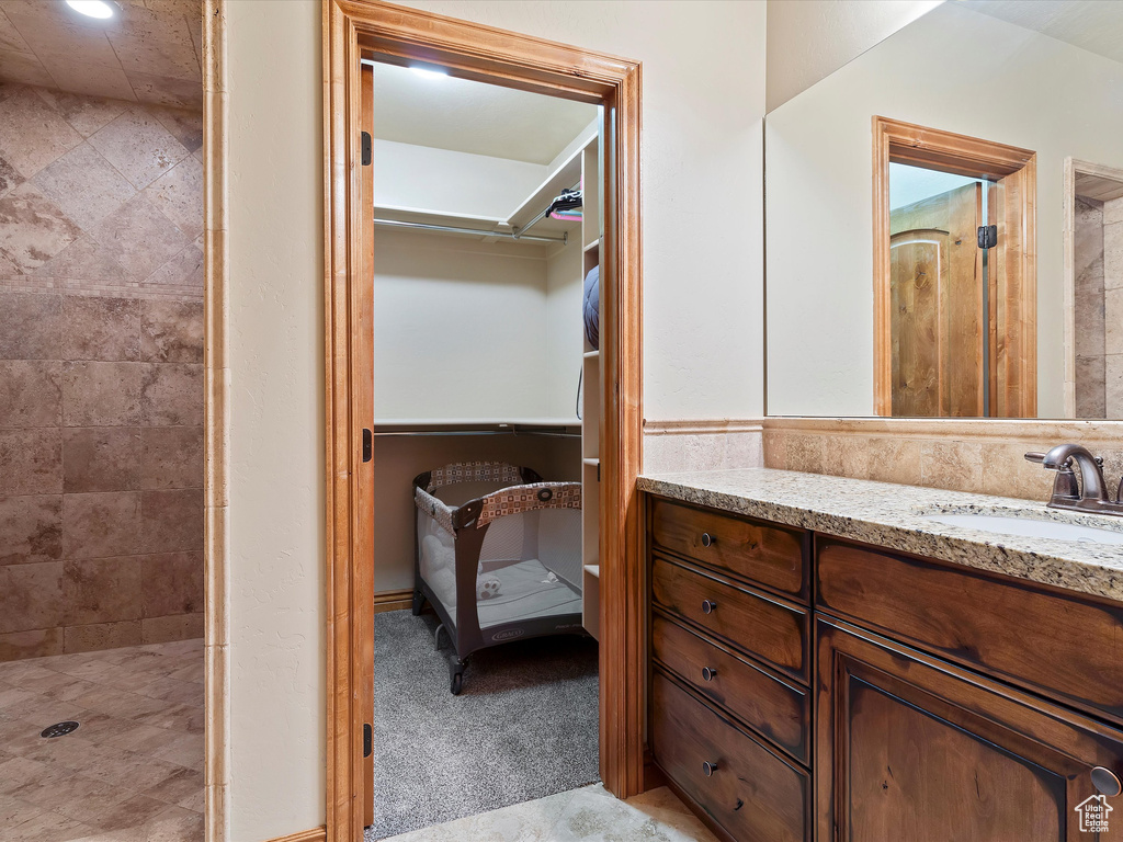 Bathroom with a tile shower and vanity