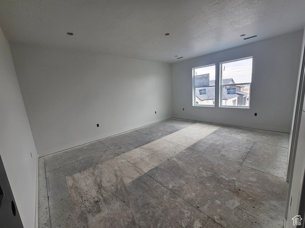 Spare room featuring visible vents and a textured ceiling