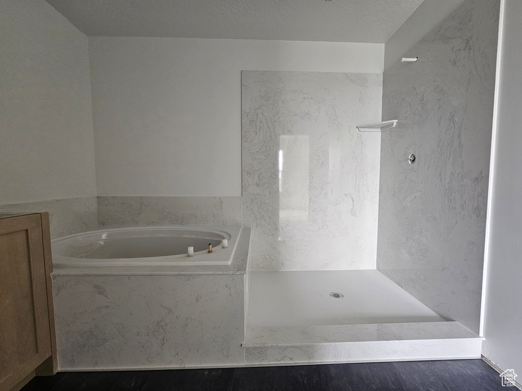 Bathroom with a shower and a garden tub