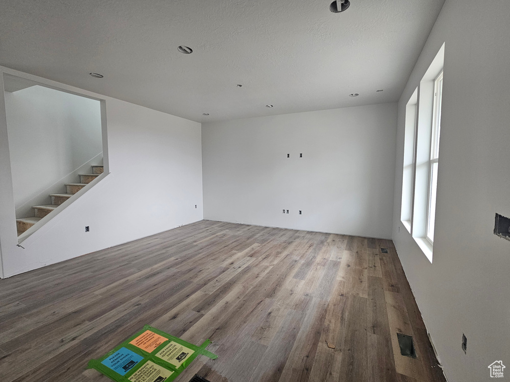 Unfurnished room with wood finished floors and stairs