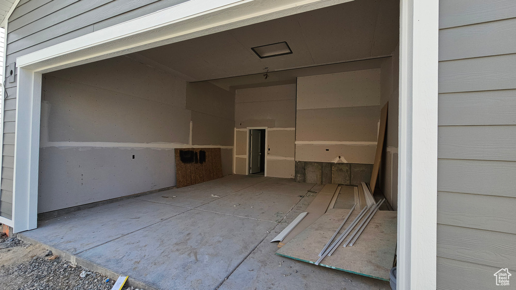 Garage featuring an attached carport