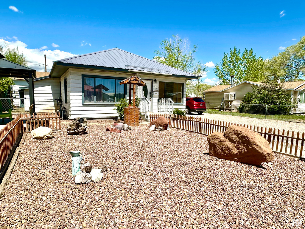 Bungalow-style home featuring fence private yard and metal roof