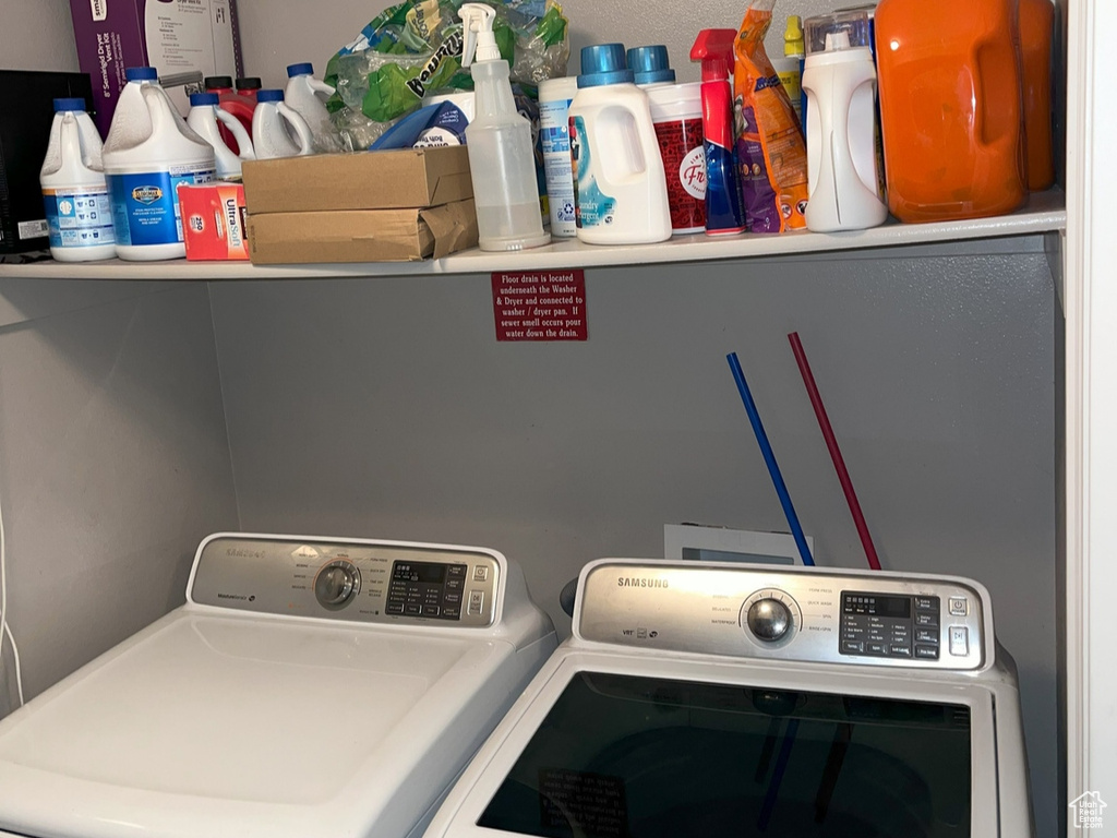 Clothes washing area with washer and clothes dryer, a textured ceiling, and crown molding