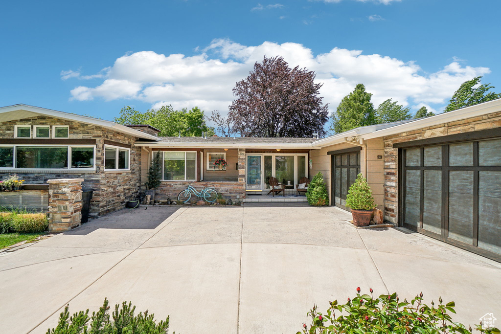 Rear view of house with stone siding
