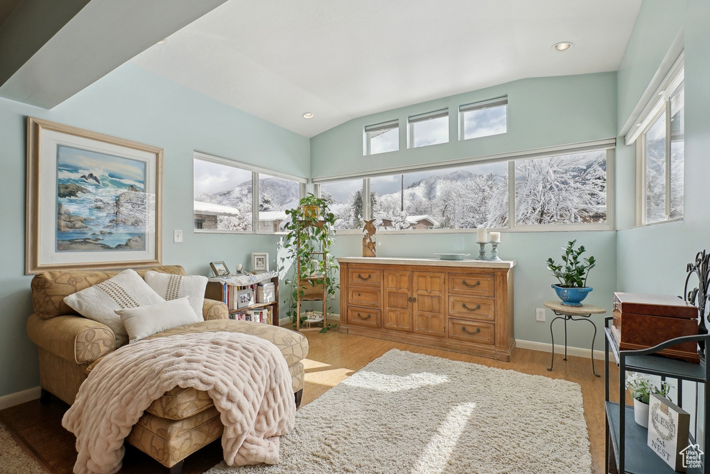 Bedroom featuring wood finished floors, baseboards, recessed lighting, and lofted ceiling
