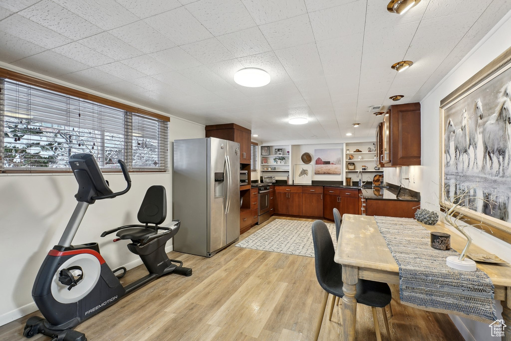 Dining area featuring light wood-style flooring and baseboards