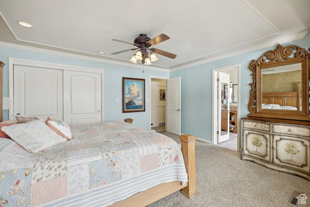 Bedroom featuring a closet, light carpet, ceiling fan, ornamental molding, and baseboards