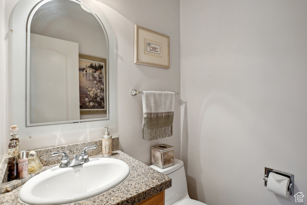 Half bath featuring toilet and vanity